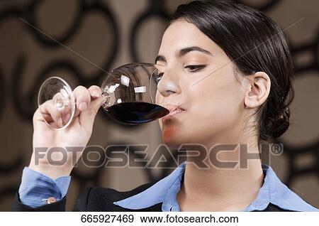 Businesswoman drinking wine View Large Photo Image Stock Photo - Businesswoman drinking wine. Fotosearch