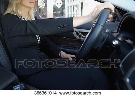 Businesswoman driving a car, Biltmore Hotel, Coral Gables, Florida, USA View Large Photo Image Picture - Businesswoman driving a car, Biltmore Hotel, Coral Gables, Florida, USA. Fotosearch