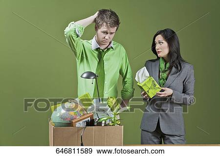 Businesswoman offering tissue papers to a fired businessman View Large Photo Image Stock Photo - Businesswoman offering tissue papers to a fired businessman. Fotosearch