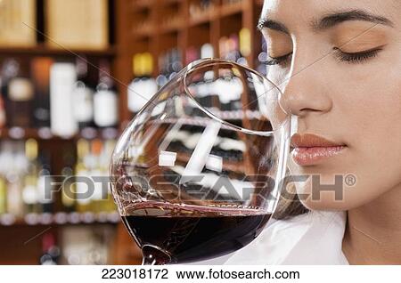 Businesswoman smelling a glass of red wine View Large Photo Image Stock Image - Businesswoman smelling a glass of red wine. Fotosearch