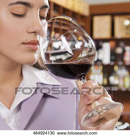 Businesswoman smelling a glass of red wine View Large Photo Image Stock Image - Businesswoman smelling a glass of red wine. Fotosearch