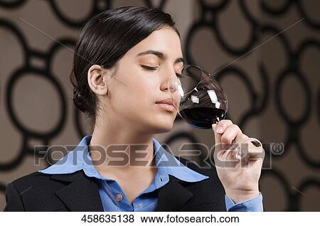 Businesswoman smelling a glass of red wine View Large Photo Image Stock Photo - Businesswoman smelling a glass of red wine. Fotosearch