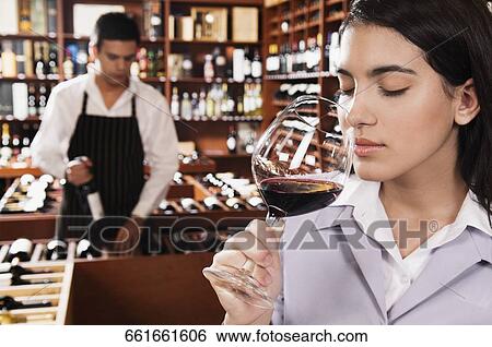 Businesswoman smelling a glass of red wine View Large Photo Image Stock Photograph - Businesswoman smelling a glass of red wine. Fotosearch
