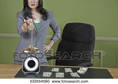 Businesswoman weighing gold jewelry View Large Photo Image Stock Image - Businesswoman weighing gold jewelry. Fotosearch