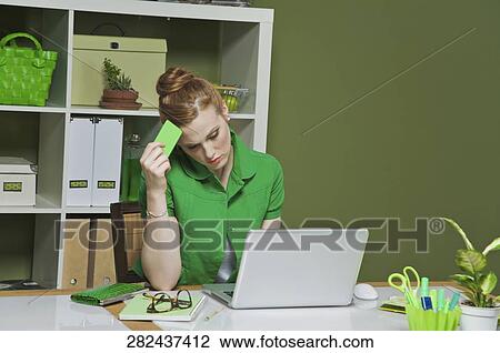 Stock Image - Businesswoman working on a laptop in the office. Fotosearch