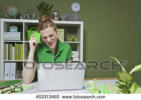 Businesswoman working on a laptop in the office View Large Photo Image Stock Image - Businesswoman working on a laptop in the office. Fotosearch