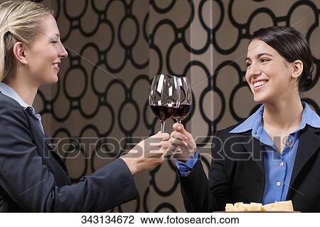 Businesswomen toasting with wine View Large Photo Image Stock Image - Businesswomen toasting with wine. Fotosearch