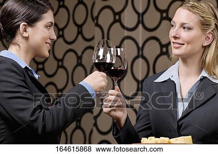 Businesswomen toasting with wine View Large Photo Image Stock Photo - Businesswomen toasting with wine. Fotosearch
