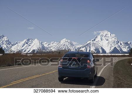Car on a road, Grand Teton National Park, Wyoming, USA View Large Photo Image Picture - Car on a road, Grand Teton National Park, Wyoming, USA. Fotosearch