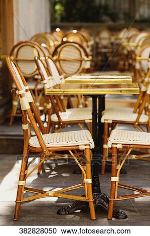 Stock Image - Chairs and a table in a restaurant. Fotosearch