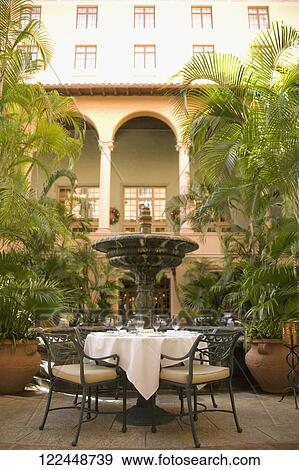 Chairs and a table in front of a hotel, Biltmore Hotel, Coral Gables, Florida, USA View Large Photo Image Stock Photo - Chairs and a table in front of a hotel, Biltmore Hotel, Coral Gables, Florida, USA. Fotosearch