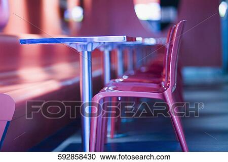 Stock Image - Chairs and tables in a restaurant. Fotosearch