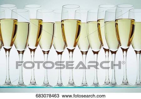 Champagne flutes in a row View Large Photo Image Stock Image - Champagne flutes in a row. Fotosearch