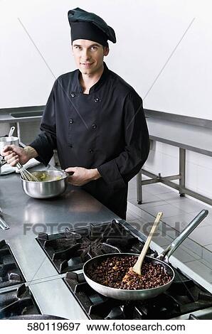 Chef cooking food in the kitchen View Large Photo Image Stock Photo - Chef cooking food in the kitchen. Fotosearch