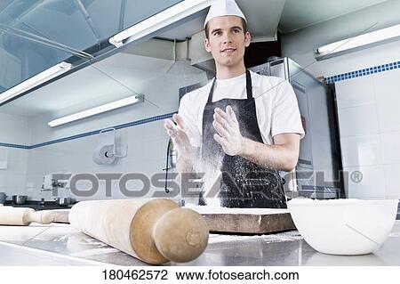 Chef dusting hands with flour View Large Photo Image Stock Image - Chef dusting hands with flour. Fotosearch