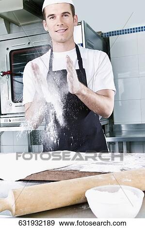 Chef dusting hands with flour View Large Photo Image Stock Photo - Chef dusting hands with flour. Fotosearch