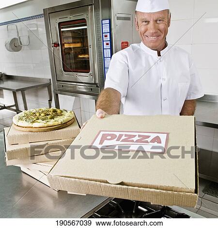 Stock Photo - Chef holding a pizza box. Fotosearch
