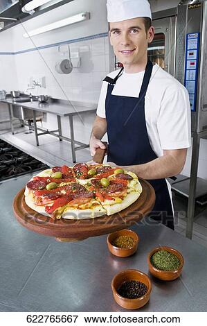 Chef preparing pizza in the kitchen View Large Photo Image Stock Photo - Chef preparing pizza in the kitchen. Fotosearch
