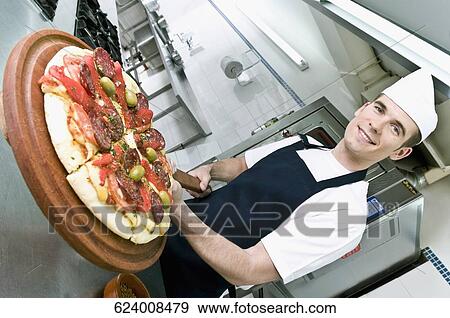 Chef preparing pizza in the kitchen View Large Photo Image Stock Photo - Chef preparing pizza in the kitchen. Fotosearch