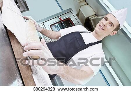 Chef rolling dough with a rolling pin View Large Photo Image Stock Photo - Chef rolling dough with a rolling pin. Fotosearch