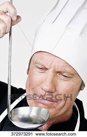 Stock Image - Chef smelling the cooked food. Fotosearch