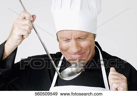 Stock Photo - Chef smelling the cooked food. Fotosearch