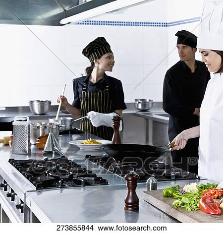 Chefs cooking food in the kitchen View Large Photo Image Picture - Chefs cooking food in the kitchen. Fotosearch