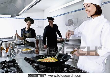 Stock Photo - Chefs cooking food in the kitchen. Fotosearch