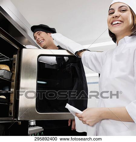 Stock Image - Chefs preparing food in the kitchen. Fotosearch