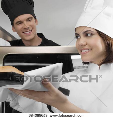 Chefs preparing food in the kitchen View Large Photo Image Stock Image - Chefs preparing food in the kitchen. Fotosearch