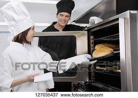 Stock Photo - Chefs preparing food in the kitchen. Fotosearch