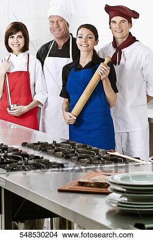 Chefs standing in the kitchen View Large Photo Image Picture - Chefs standing in the kitchen. Fotosearch