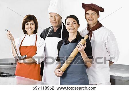Chefs standing in the kitchen View Large Photo Image Stock Image - Chefs standing in the kitchen. Fotosearch