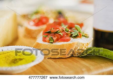 Close-up of a bowl of soup and a bread garnished with tomato View Large Photo Image Stock Photo - Close-up of a bowl of soup and a bread garnished with tomato. Fotosearch