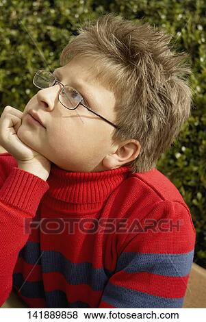 Close-up of a boy with his hand on his chin View Large Photo Image Stock Photo - Close-up of a boy with his hand on his chin. Fotosearch