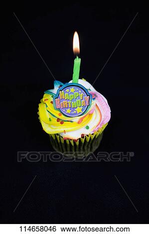 Close-up of a burning candle on a birthday cake View Large Photo Image Stock Photograph - Close-up of a burning candle on a birthday cake. Fotosearch