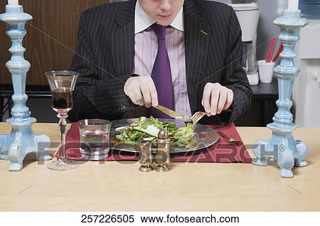 Close-up of a businessman having lunch in the office View Large Photo Image Stock Photography - Close-up of a businessman having lunch in the office. Fotosearch