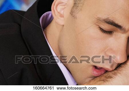 Stock Image - Close-up of a businessman in a bar. Fotosearch