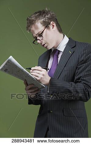 Close-up of a businessman marking on a newspaper View Large Photo Image Stock Image - Close-up of a businessman marking on a newspaper. Fotosearch