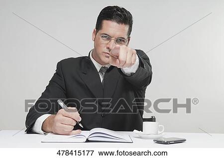 Stock Photo - Close-up of a businessman pointing towards the camera. Fotosearch