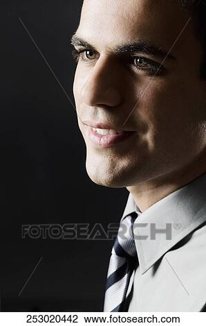 Stock Image - Close-up of a businessman smiling. Fotosearch