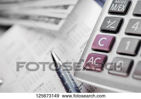 Stock Photo - Close-up of a calculator and a pen on a calendar. Fotosearch