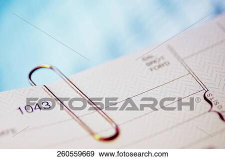 Close-up of a check with a paper clip View Large Photo Image Stock Photo - Close-up of a check with a paper clip. Fotosearch