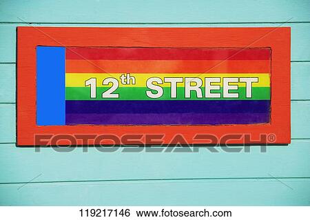 Close-up of a colorful signboard on a gay flag background, 12Th Street, Miami Beach, Florida, USA View Large Photo Image Stock Photograph - Close-up of a colorful signboard on a gay flag background, 12Th Street, Miami Beach, Florida, USA. Fotosearch