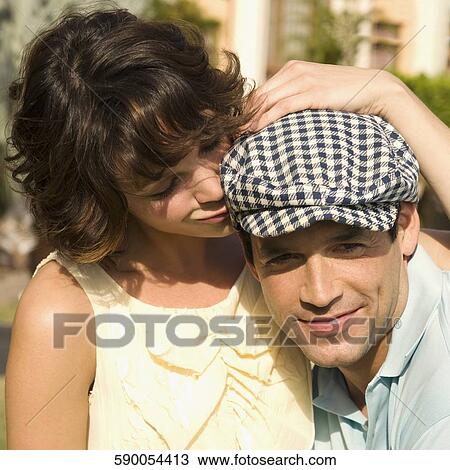 Stock Image - Close-up of a couple romancing in a hotel lawn, Biltmore Hotel, Coral Gables, Florida, USA. Fotosearch