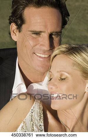 Stock Image - Close-up of a couple smiling, Biltmore Golf Course, Coral Gables, Florida, USA. Fotosearch