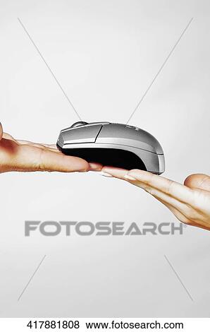 Close-up of a couple's hands holding a computer mouse View Large Photo Image Stock Photo - Close-up of a couple's hands holding a computer mouse. Fotosearch