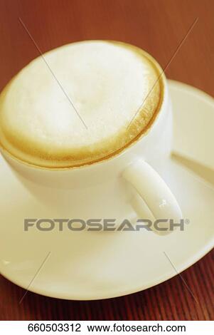 Close-up of a cup of cappuccino on a saucer View Large Photo Image Stock Image - Close-up of a cup of cappuccino on a saucer. Fotosearch