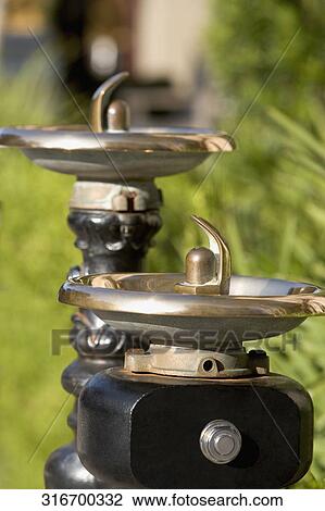 Stock Image - Close-up of a drinking fountain in a park. Fotosearch