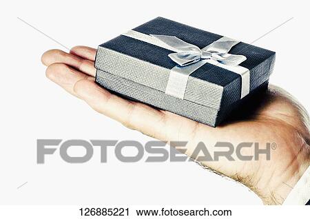 Close-up of a gift on a man's palm View Large Photo Image Stock Image - Close-up of a gift on a man's palm. Fotosearch